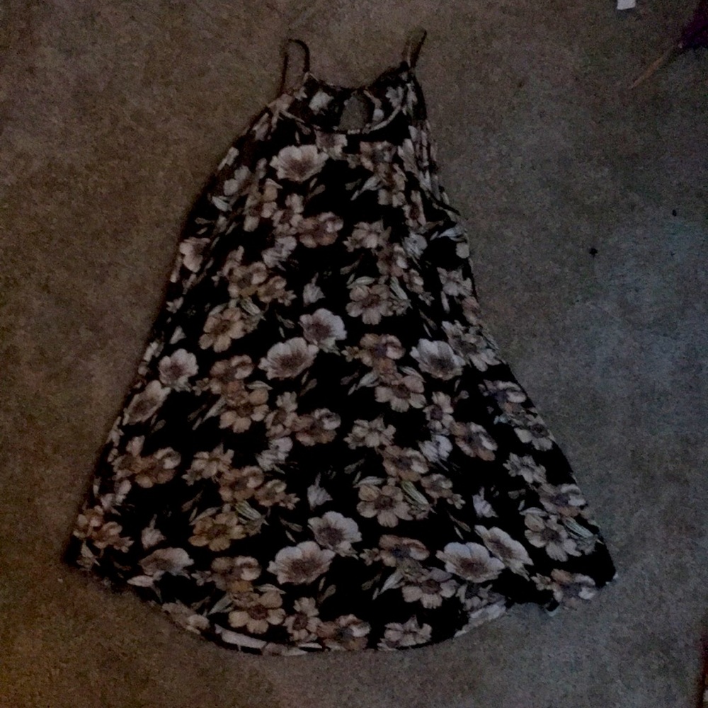 Brown dress with floral print. Slit and button in the back.